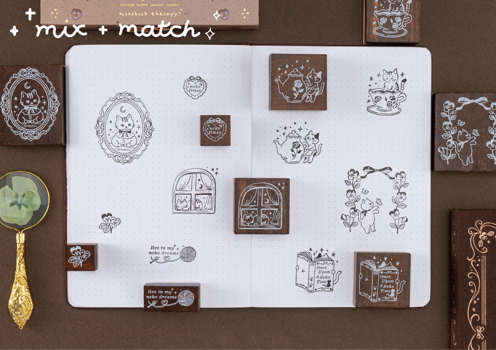 A variety of cat-themed stamp designs scattered across a journal page with the text 'mix + match,' demonstrating the creative versatility of the stamp set.