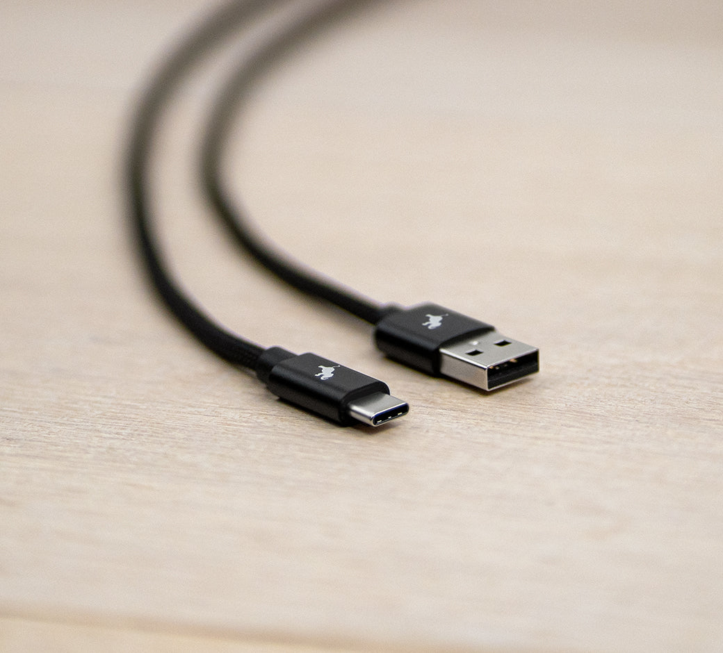 Close-up of a USB to USB-C braided charging cable.