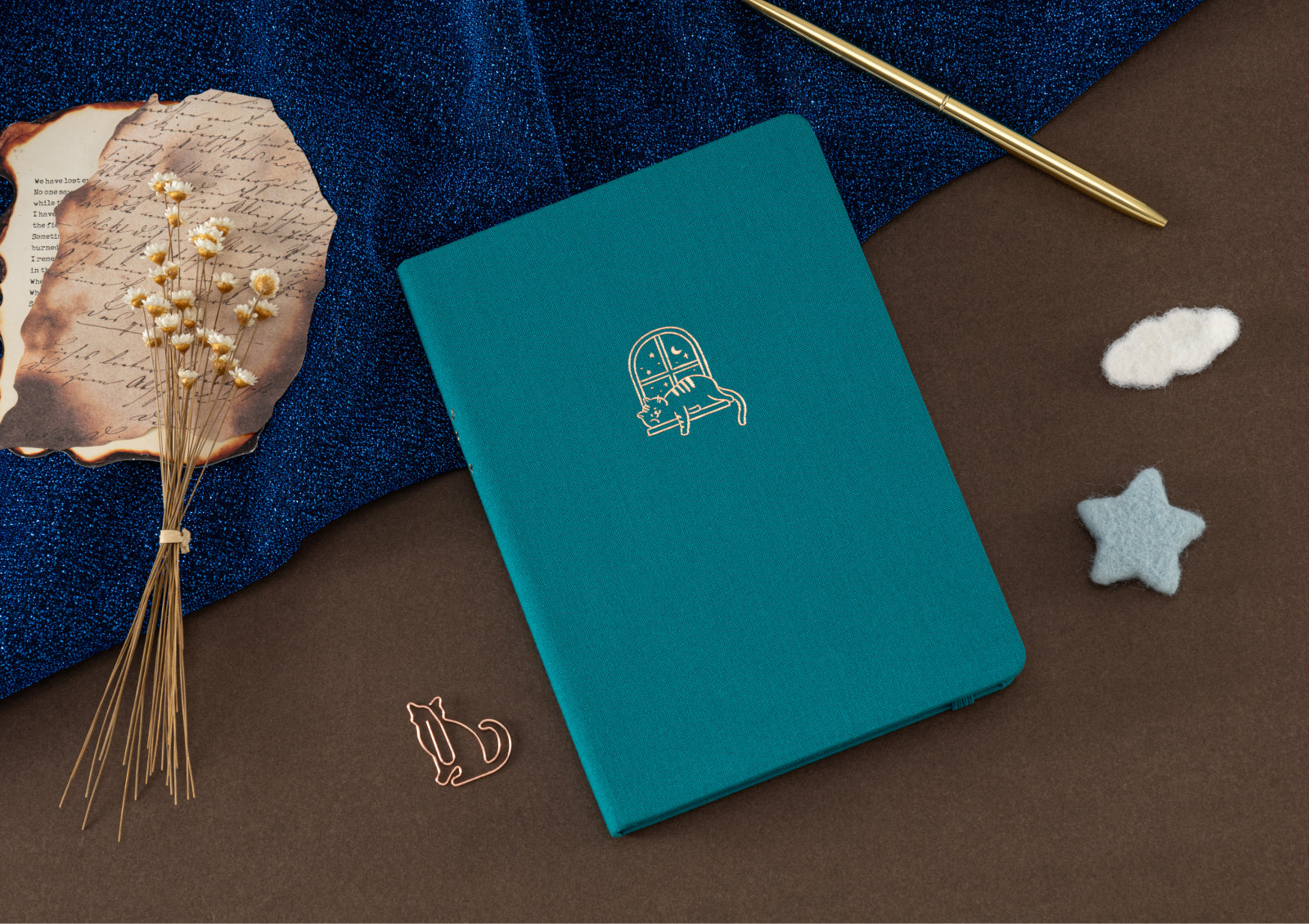 Tsuki Neko Dreams Sleepy Neko Notebook held in hands, highlighting its compact size and smooth linen texture—perfect for journaling.