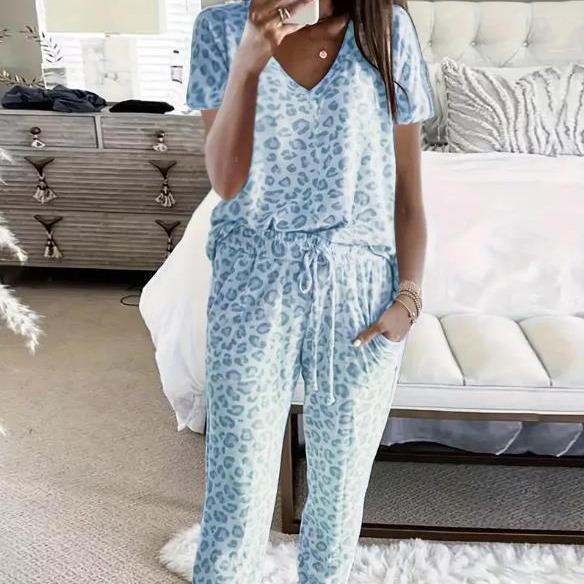 Women's V-NeckLeopard Print Loungewear Set. This relaxed-fit two-piece features a short-sleeve top and pants for effortlessly chic, casual comfort.