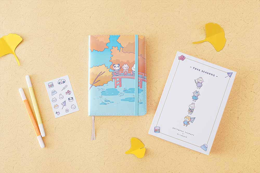 Tsuki ‘Four Seasons: Autumn Edition’ Bullet Journal made with milkkoyo with eco-friendly gift box and free stickers sheet with pencils and autumn leaves on light brown background