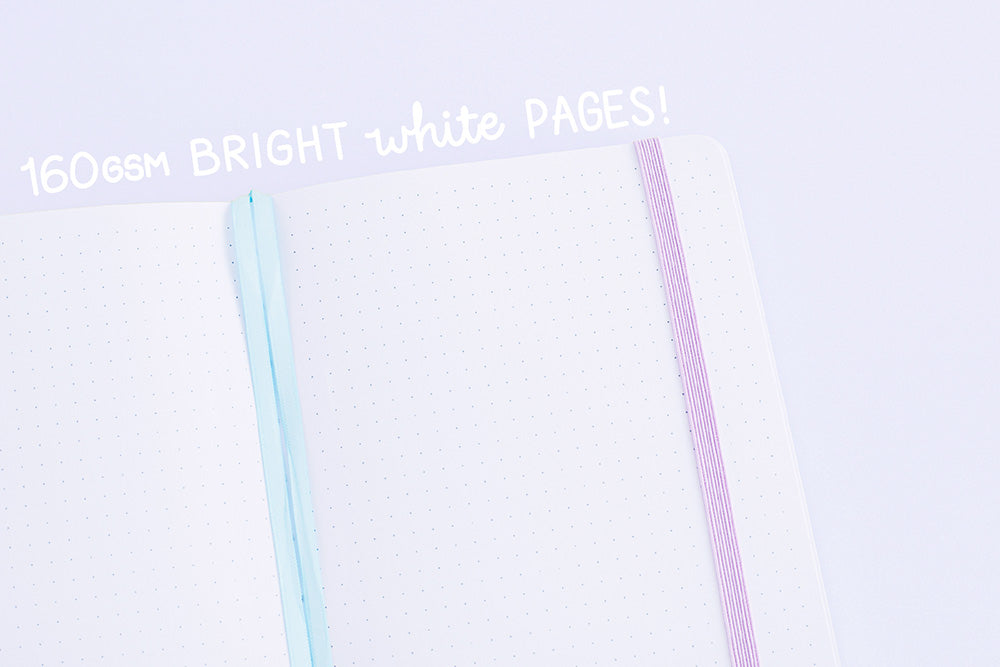 Close up of Tsuki Four Seasons: Summer Edition Bullet Journal designed with @milkkoyo on open pages with 160GSM bright white pages on lilac background