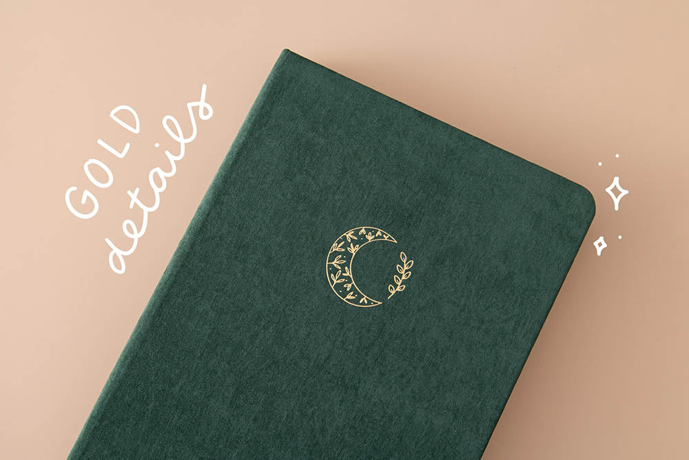 Close up of Tsuki ‘Midnight Garden’ Limited Edition Bullet Journal with gold details on beige background