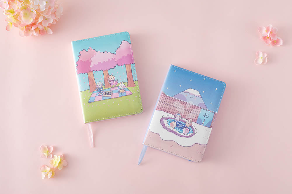 spring and winter edition notebook in pink background