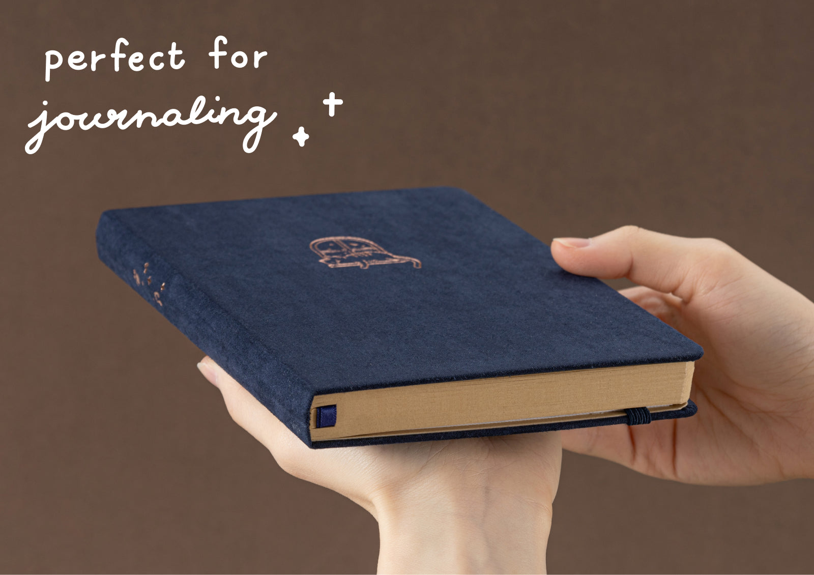 Tsuki Neko Dreams Midnight Neko Notebook held alongside red and teal editions, styled with clouds and vintage letters.