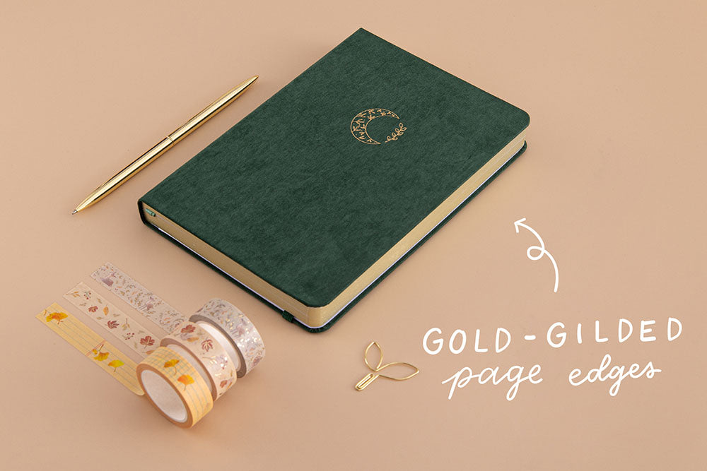 Tsuki ‘Midnight Garden’ Limited Edition Bullet Journal with gold gilded page edges and free paperclip gift with Tsuki ‘Maple Dreams’ Washi Tape Set and gold pen on beige background