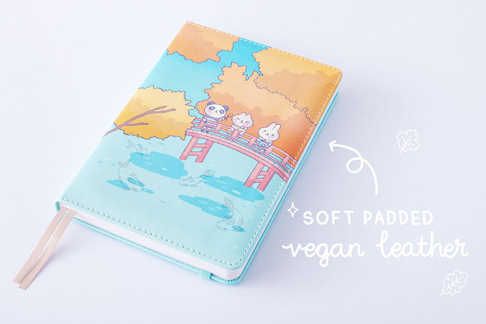 Tsuki ‘Four Seasons: Autumn Edition’ Bullet Journal made with milkkoyo with soft padded vegan leather on lilac background