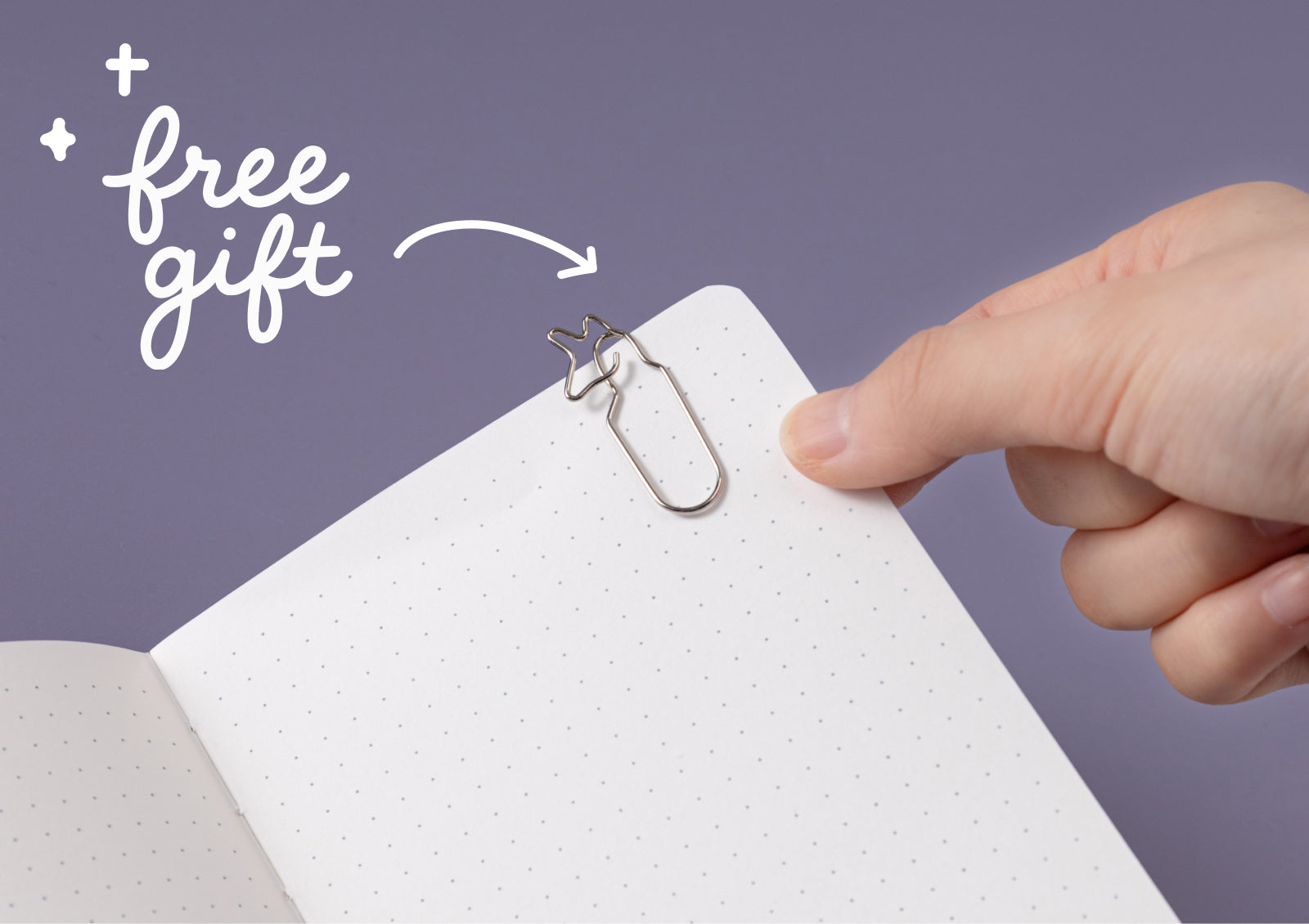 Hands opening the Tsuki Moonflower Magic Moonmist Meadow Travel Notebook, showing dotted pages inside.