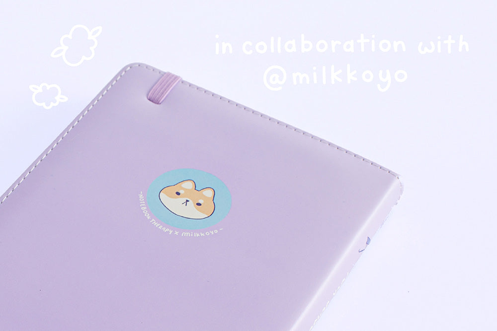 Close up of the back cover of Tsuki Four Seasons: Summer Edition Bullet Journal designed in collaboration with @milkkoyo on lilac background