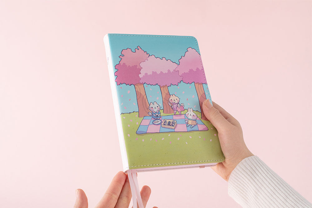 holding tsuki spring edition in pink background