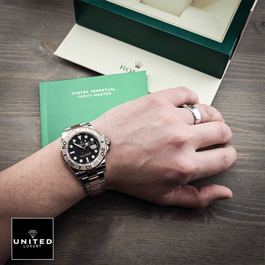 Rolex Yatch Master 116621 Rose Gold Black Dial Replica warranty card next to