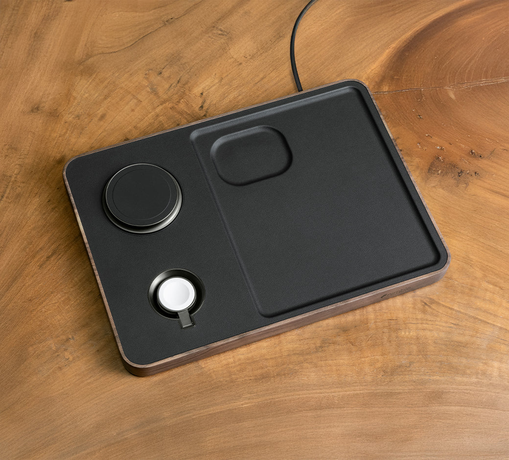 Wooden charging station with Apple devices and accessories.