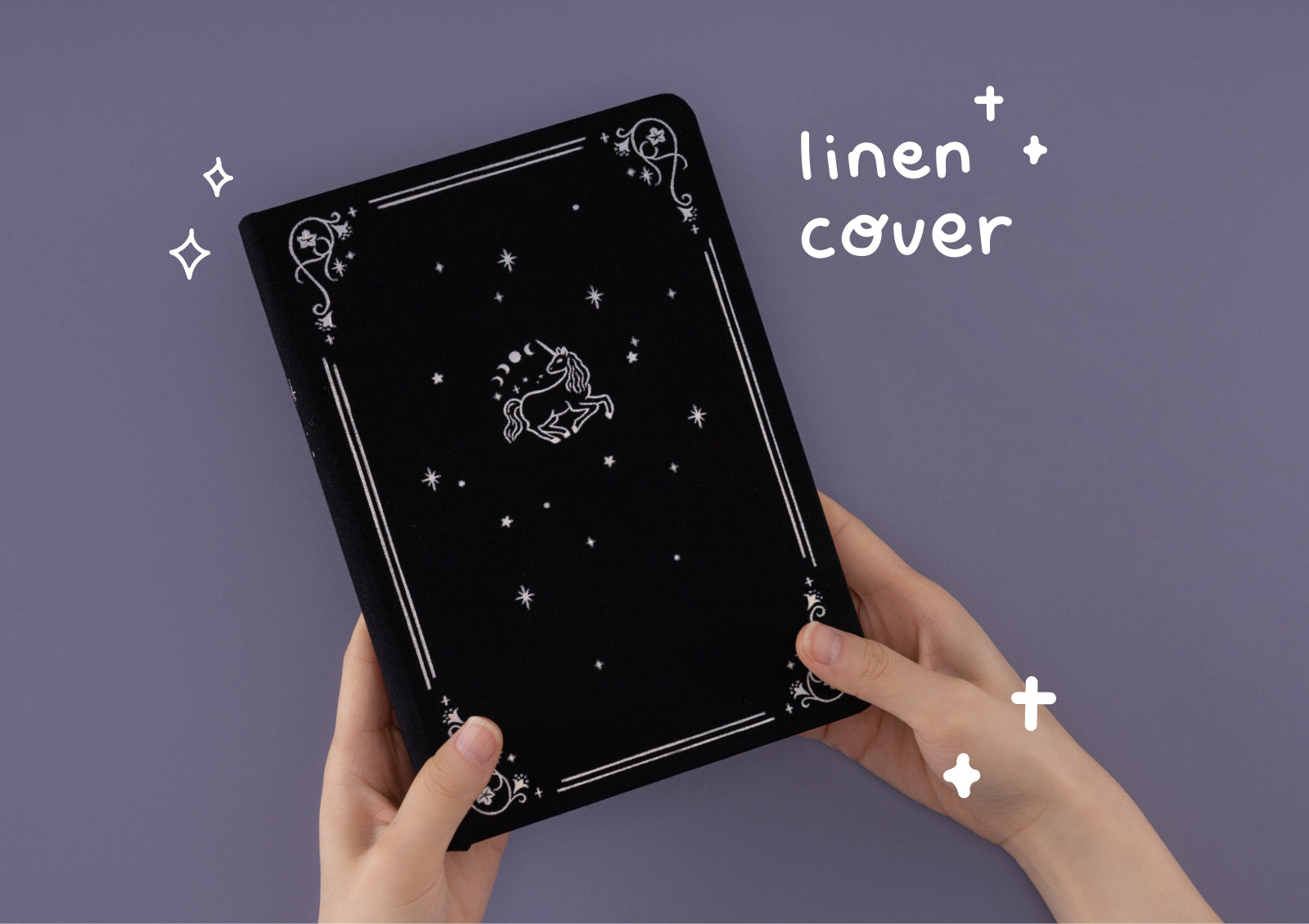 Flat lay of Tsuki Moonflower Magic Lunar Unicorn Notebook black edition with celestial-themed stationery accessories.
