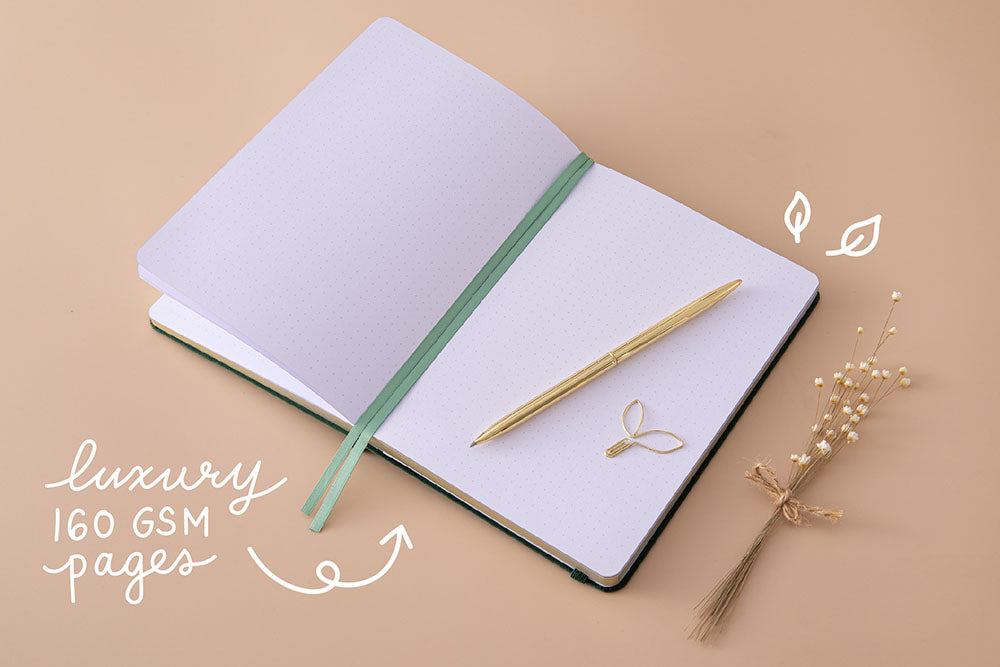 Tsuki ‘Midnight Garden’ Limited Edition Bullet Journal with luxury 160GSM pages and two bookmark ribbons and free paperclip gift with gold pen and dried flowers on beige background