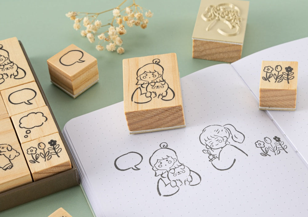 Girl stamps with speech bubble on bullet journal page