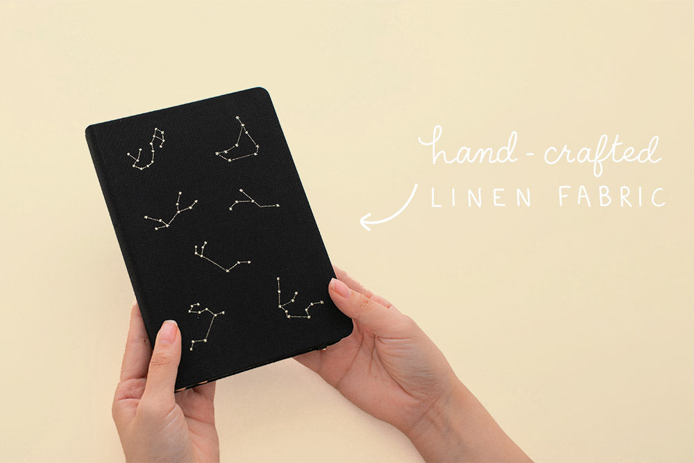 Constellation and galaxy themed bullet journal with hand-crafted linen fabrics