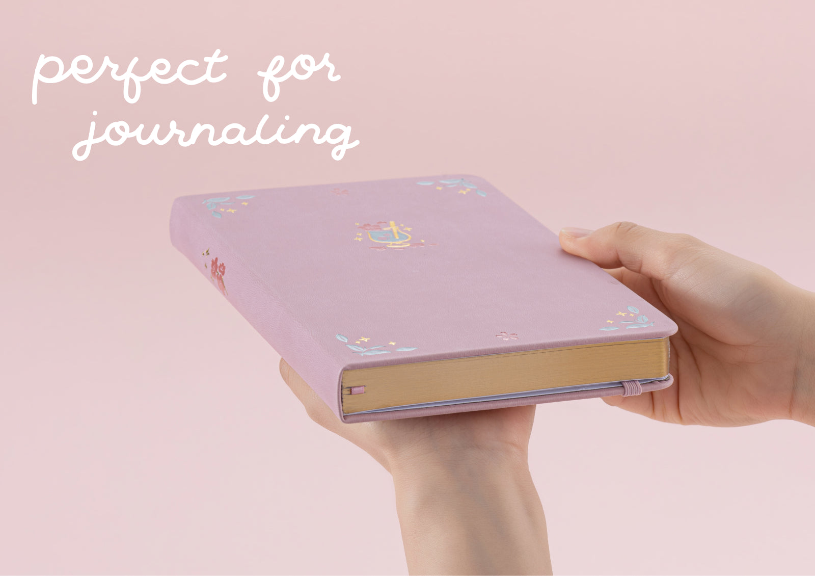 A side view of the notebook held by hands to showcase the premium gold gilded edges and thick pages.