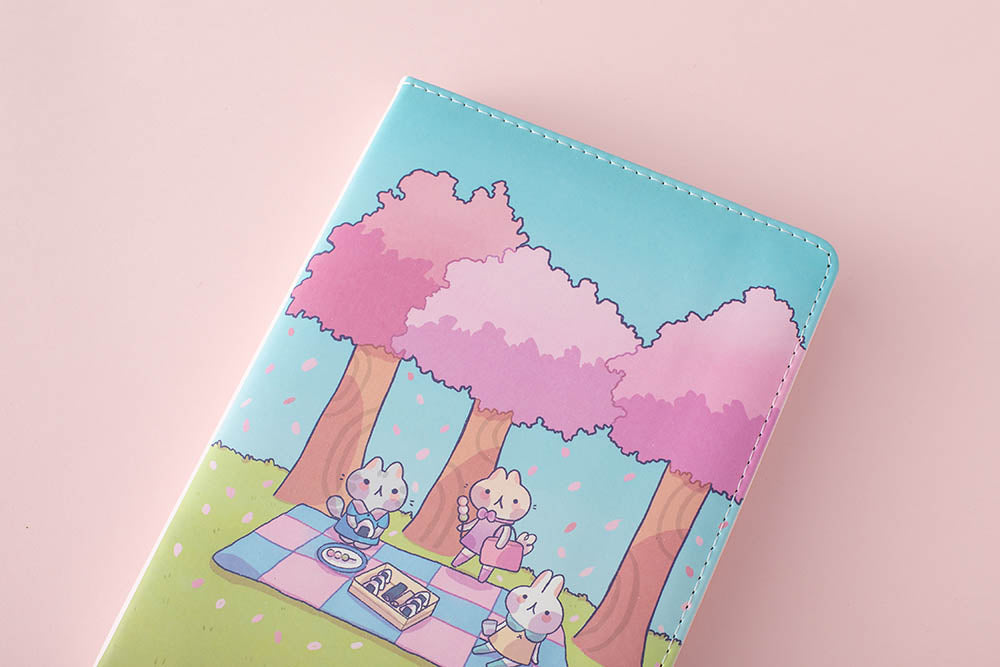 zoomed in front cover of the spring notebook in pink background