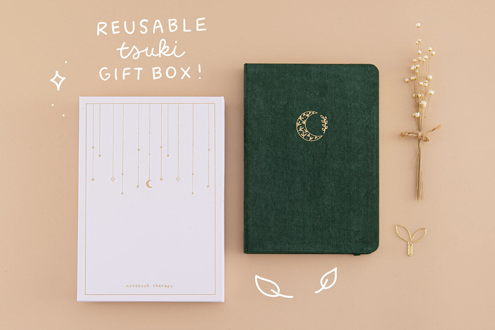 Tsuki ‘Midnight Garden’ Limited Edition Bullet Journal with reusable Tsuki gift box and free paperclip gift with dried flowers on beige background