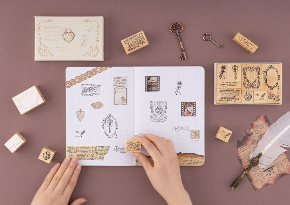 Flatlay of notebook therapy love lock stamps and bullet journal with washi tapes