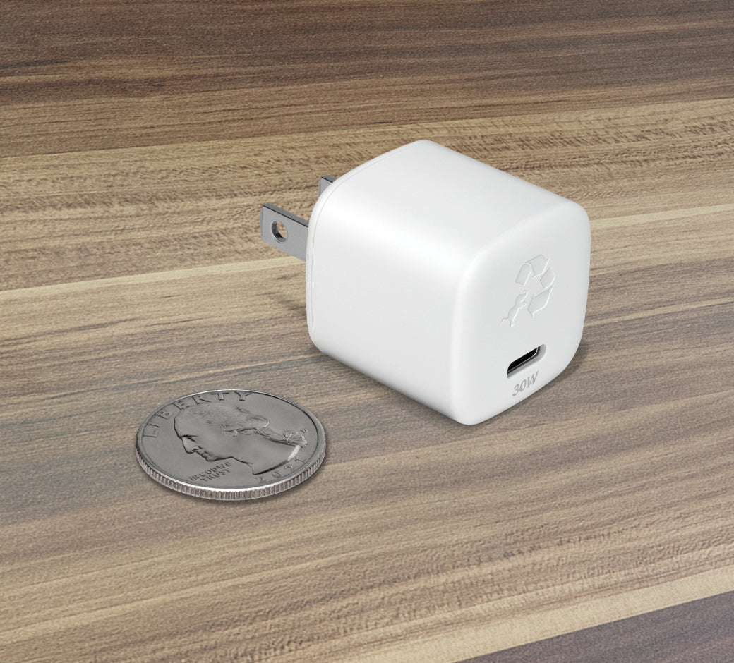 White 30W USB-C wall charger next to a quarter, showcasing the compact design