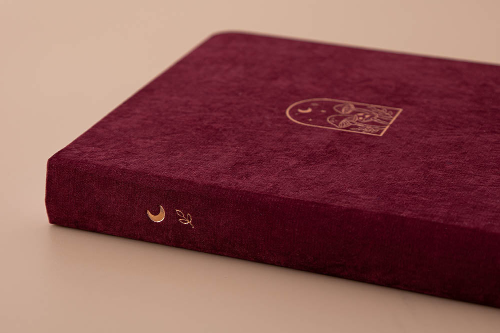 Close up of spine of Tsuki ‘Kinoko’ Limited Edition Bullet Journal on beige background