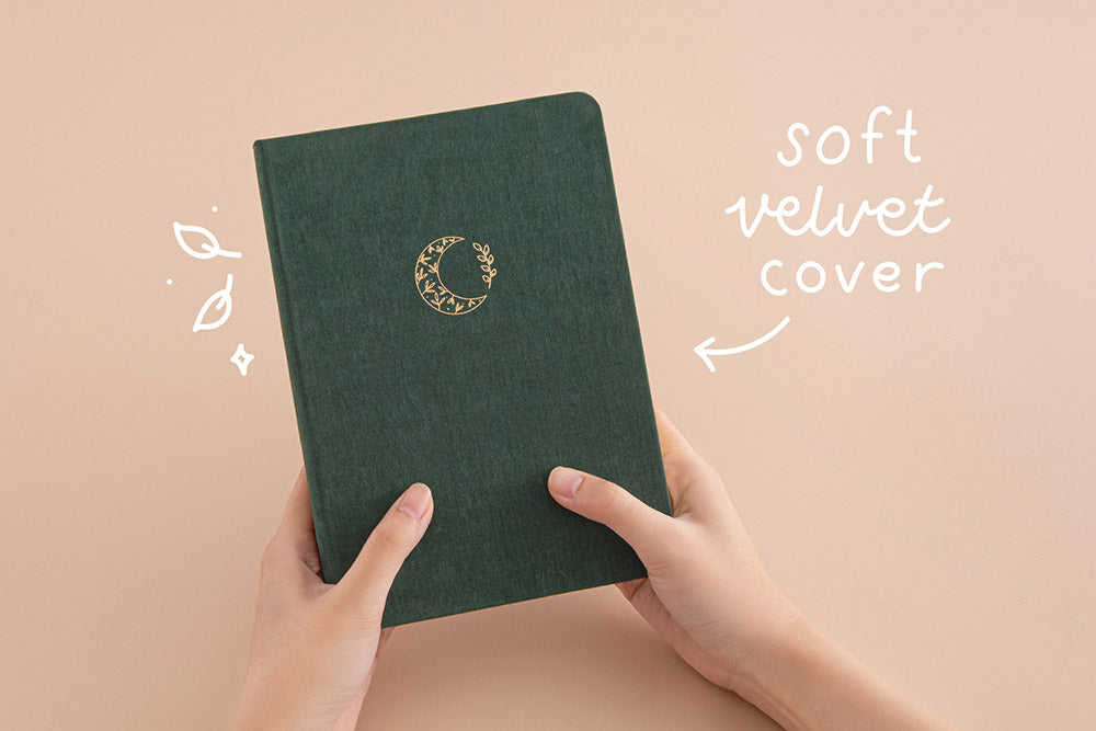 Tsuki ‘Midnight Garden’ Limited Edition Bullet Journal with soft velvet cover held in hands in beige background