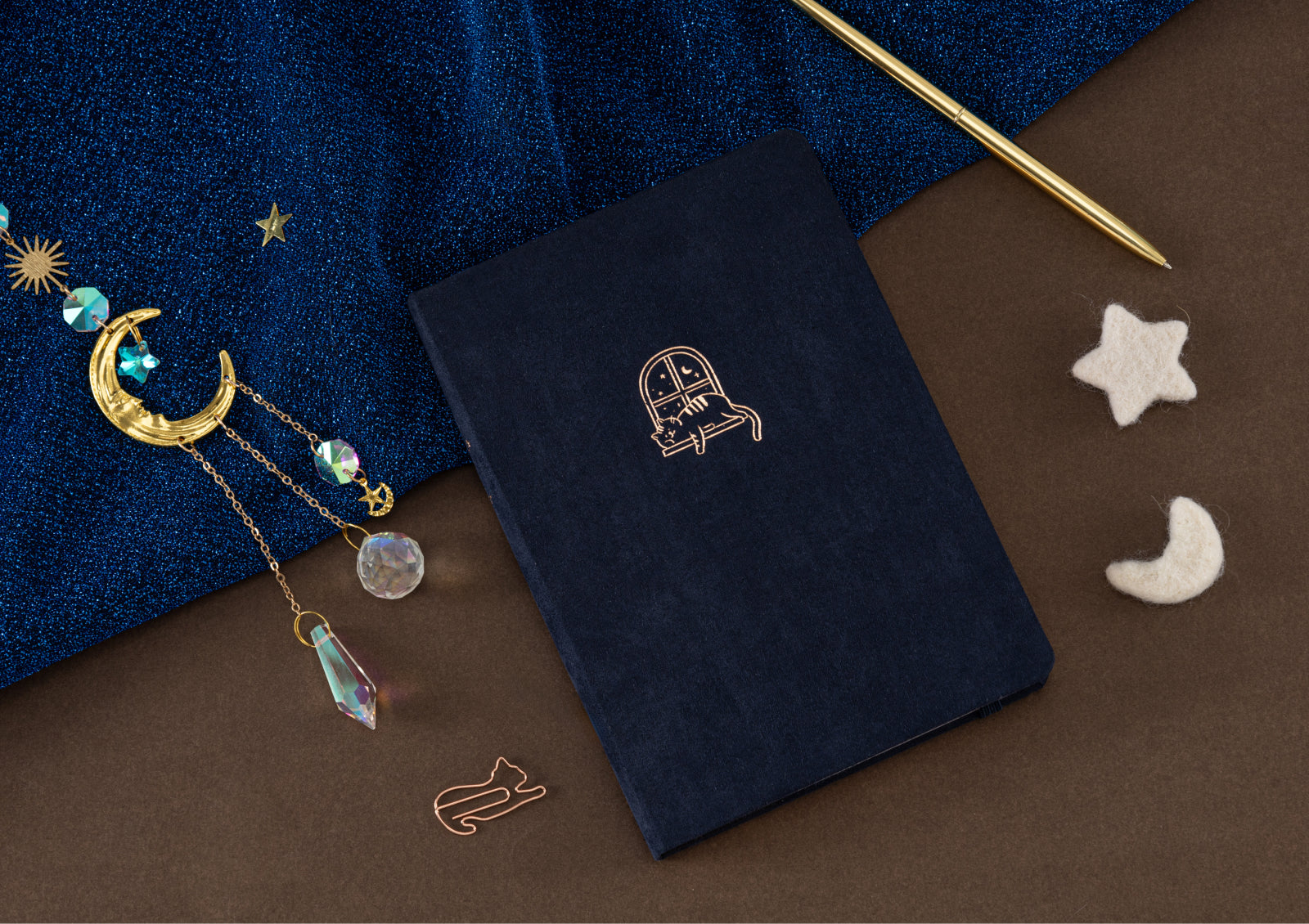 Tsuki Midnight Neko Dreams notebook held in hands, showing compact size perfect for journaling.