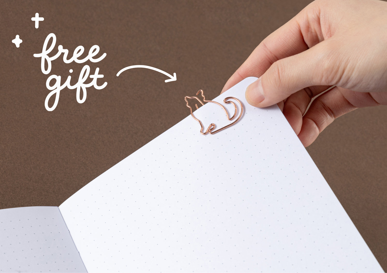 Free rose gold cat-shaped paper clip included with the Tsuki Neko Dreams Sleepy Neko Notebook.