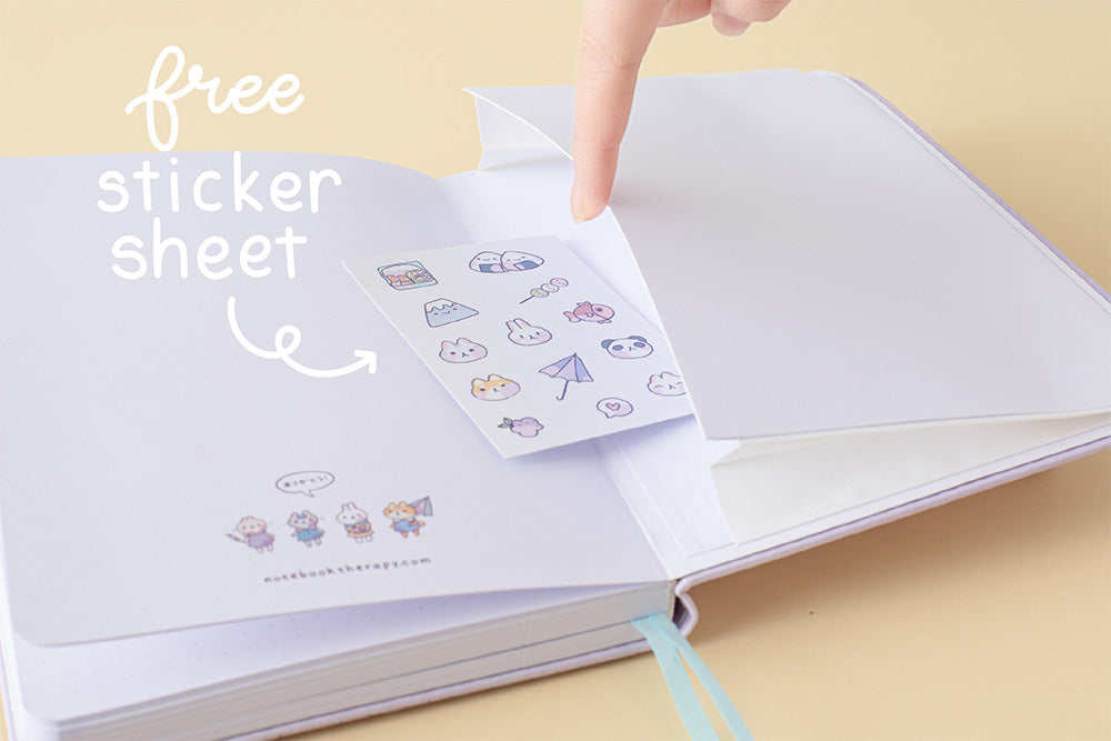 Close up of open back page pocket of Tsuki Four Seasons: Summer Edition Bullet Journal designed with @milkkoyo with free sticker sheet on honey yellow background