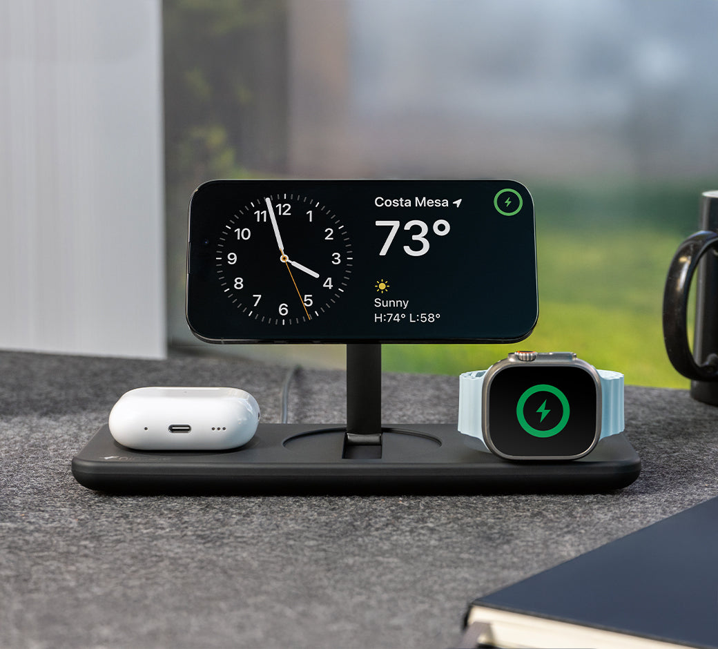 Black charging dock with multiple charging slots for devices.