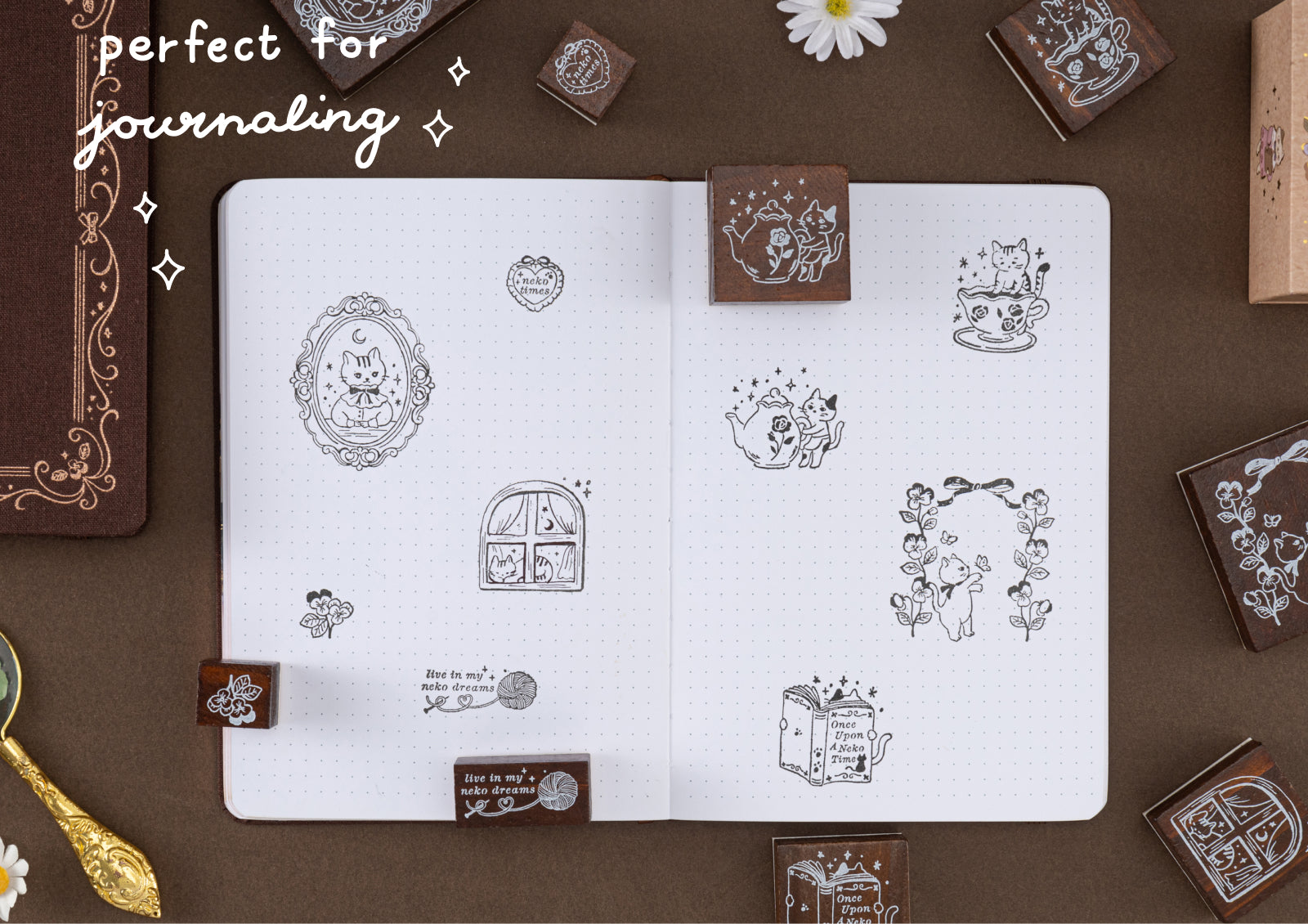 A dotted journal spread filled with various cat-themed stamp impressions, accompanied by the text 'perfect for journaling' and gold stationery accents.