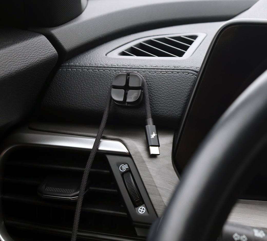 USB-C charging cable mounted on a magnetic holder inside a car.