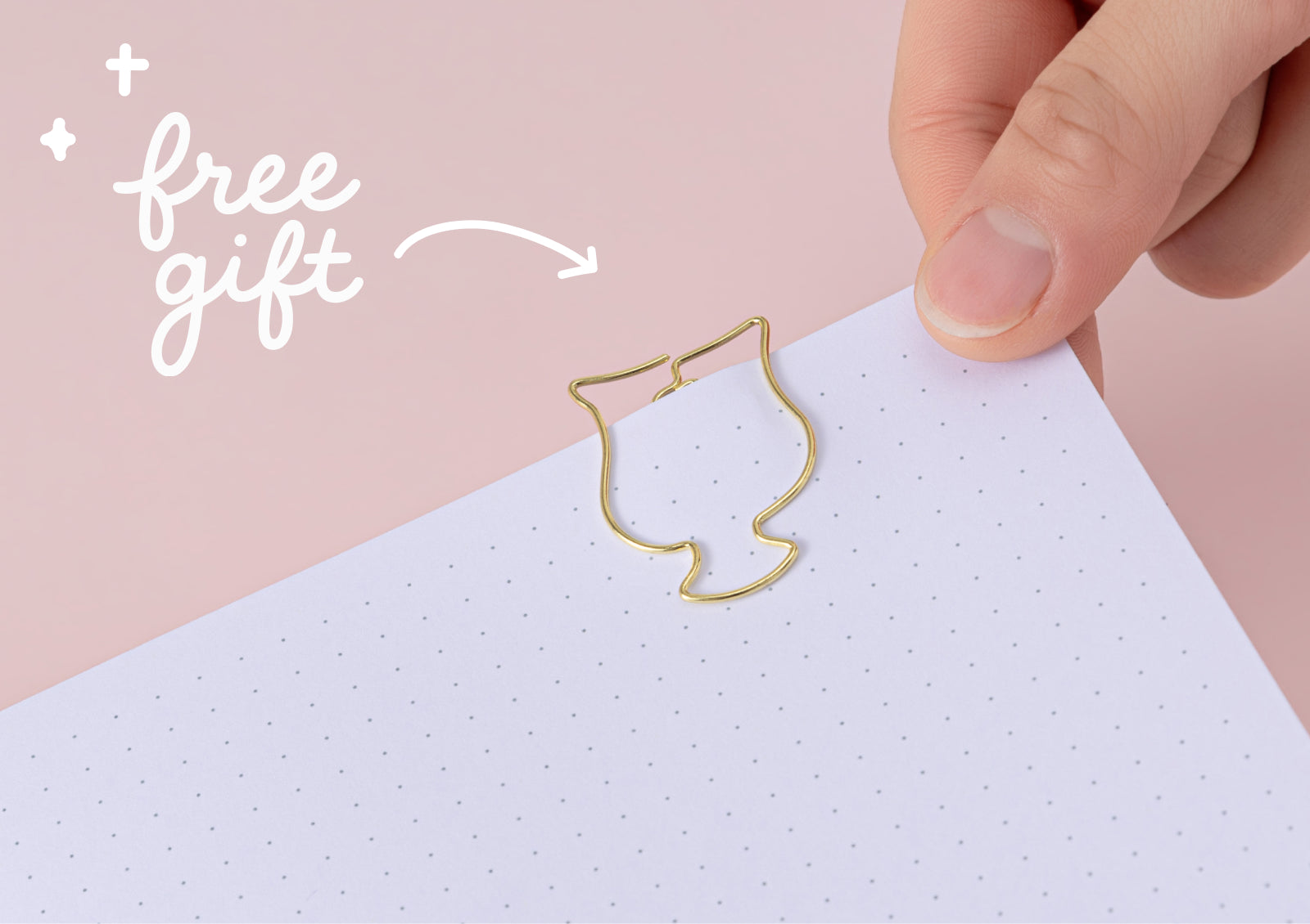 A gold-toned paperclip shaped like a matcha cup being placed on a dot grid page, labeled as a free gift.